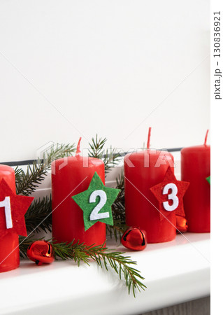 Four Advent red candles with numbers, fir branches and Christmas zero waste decorations in windowsill. Holiday preparation copy space for text. Catholic traditions of Christmas new year winter Four Advent red candles with numbers, fir branches and Christmas zero waste decorations in windowsill. Holiday preparation copy space for text. Catholic traditions of Christmas new year winter 130836921