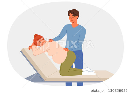 Man gives massage to pregnant woman kneeling on hospital bed waiting for labor to begin Man gives massage to pregnant woman kneeling on hospital bed waiting for labor to begin 130836923
