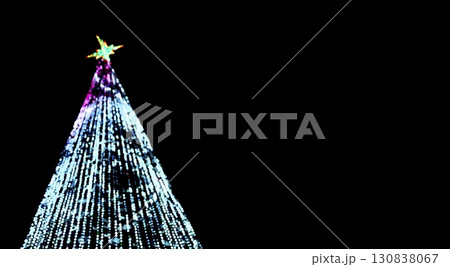 Christmas tree with ornaments and lights in festive outdoor setting. fir decorated with shiny tinsel 130838067