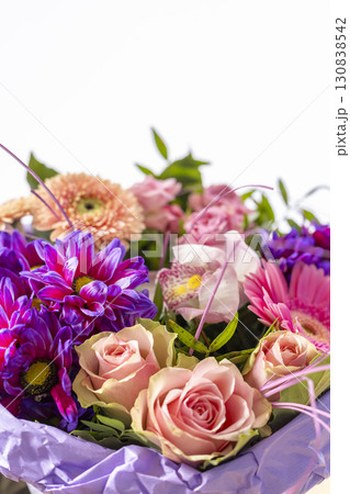 Beautiful bouquet of colorful flowers wrapped in purple paper is showing freshness and beauty 130838542