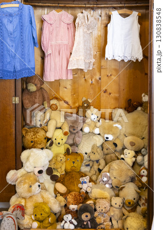 Many teddy bears filling a wooden wardrobe with hanging vintage clothes in Jaromerice nad Rokytnou, Czechia Many teddy bears filling a wooden wardrobe with hanging vintage clothes in Jaromerice nad Rokytnou, Czechia 130838548