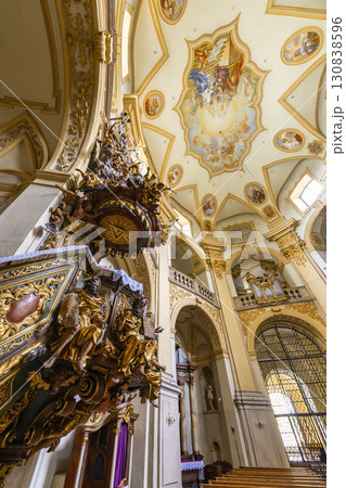 Ornate pulpit and frescoes decorating the ceiling of the Church of the Assumption of the Blessed Virgin Mary in Basilica of the Visitation of the Blessed Virgin Mary in Wambierzyce, Poland 130838596