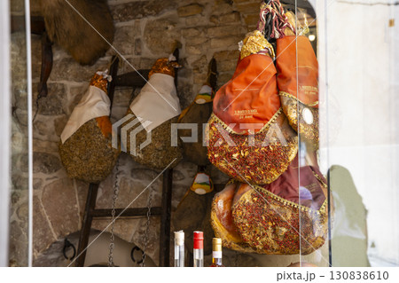 Italian hams hanging in a delicatessen in Assisi, Umbria 130838610