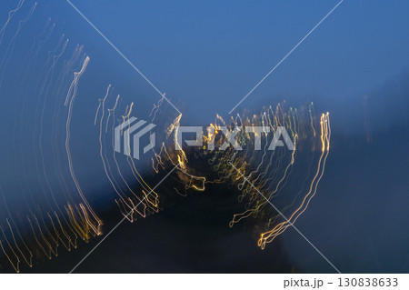 Light trails creating an abstract pattern against a dark blue sky in Tuscany 130838633