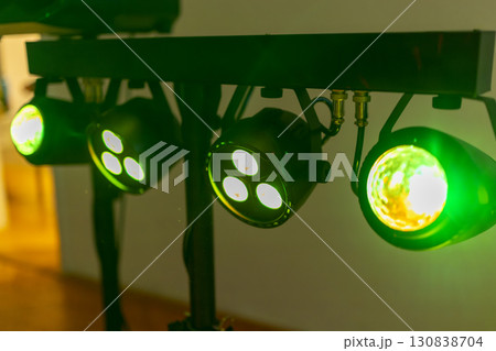 Green spotlights shining on a metal bar, creating a vibrant atmosphere 130838704
