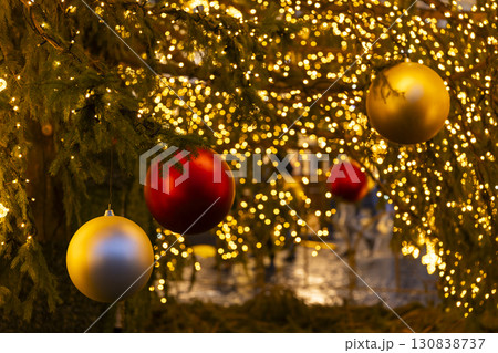 Christmas tree decorated with colorful balls and glowing lights celebrating holidays 130838737