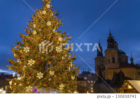 Christmas tree illuminating Old Town Square in Prague at twilight 130838741