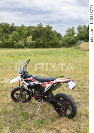 Supermoto bike parked in a field near Grignan in Drome, France 130838778
