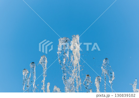 Splashes and jets of water against light background. Splashes and jets of water against light background. 130839102