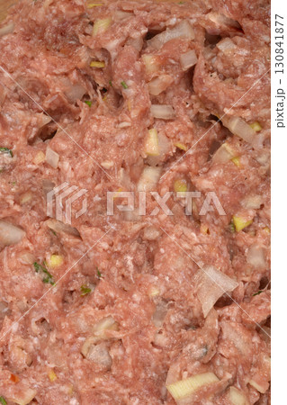 Raw ground pork and beef mixed with onions and spice Raw ground pork and beef mixed with onions and spice 130841877