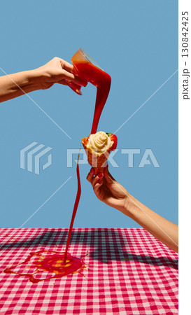 Hands pouring tomato sauce over spaghetti cone with tomato on checkered tablecloth Hands pouring tomato sauce over spaghetti cone with tomato on checkered tablecloth 130842425