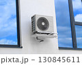 Condenser unit or compressor outside of residential building. Unit of central air conditioner AC or heating ventilation air conditioning system HVAC. Electric fan AC hangs on the wall 130845611