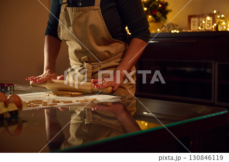 Woman Baking Gingerbread Cookies in a Warm Christmas Kitchen Setting Woman Baking Gingerbread Cookies in a Warm Christmas Kitchen Setting 130846119