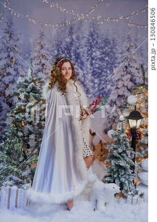 Festive girl in a winter wonderland 130846506