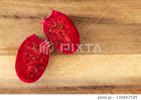 Halved prickly pear fruit on wood boar. Ripe cactus fruit Opuntia 130847595