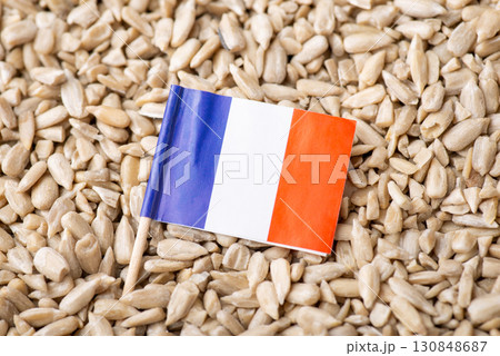 Flag of France on sunflower seeds. Origin of grain, growing sunflowers in France concept Flag of France on sunflower seeds. Origin of grain, growing sunflowers in France concept 130848687