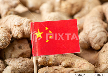Flag of China on ginger. Origin of spices, trade of ginger around the world concept Flag of China on ginger. Origin of spices, trade of ginger around the world concept 130848715