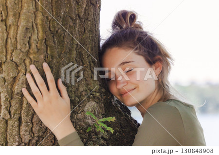 Embracing the serenity of nature, finding a serene and peaceful moment with a majestic tree Embracing the serenity of nature, finding a serene and peaceful moment with a majestic tree 130848908