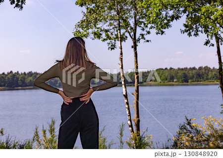 Contemplating Nature Enjoying a Serene Moment by the Lakeside Surrounded by Natural Beauty Contemplating Nature Enjoying a Serene Moment by the Lakeside Surrounded by Natural Beauty 130848920