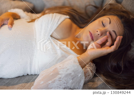 Pregnant Woman Resting Peacefully on a Comfortable Couch, Reflecting Calmness Pregnant Woman Resting Peacefully on a Comfortable Couch, Reflecting Calmness 130849244