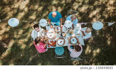Top view of grandparents, parents and kids during grill party. Top view of grandparents, parents and kids during grill party. 130849685