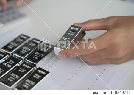 Silver Trading Businessman invest in trading silver on the stock exchange price rising. Silver Trading Businessman invest in trading silver on the stock exchange price rising. 130849711