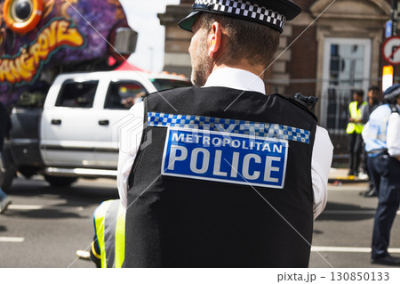 UK Metropolitan Police Uniformed Officer Managing Crowd UK Metropolitan Police Uniformed Officer Managing Crowd 130850133