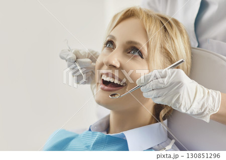Happy patient woman individual examination in dental clinic for oral health treatment, dentist exam Happy patient woman individual examination in dental clinic for oral health treatment, dentist exam 130851296