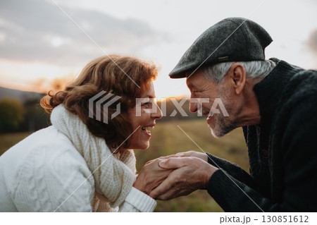 Senior couple holding hands, standing face to face. Senior couple holding hands, standing face to face. 130851612