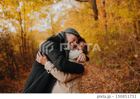 Older couple spending time outdoors in fall season. Older couple spending time outdoors in fall season. 130851731