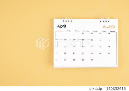 April 2026 desk calendar on yellow color background, position with copy space. 130852616