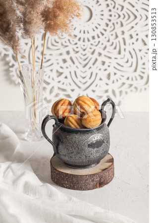 Russian traditional homemade cookies Nuts with condensed milk on an vintage jar on a wooden stand Russian traditional homemade cookies Nuts with condensed milk on an vintage jar on a wooden stand 130853513