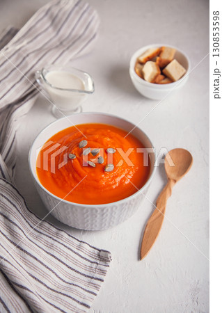 Pumpkin soup-puree with cream and seeds on a white background 130853598