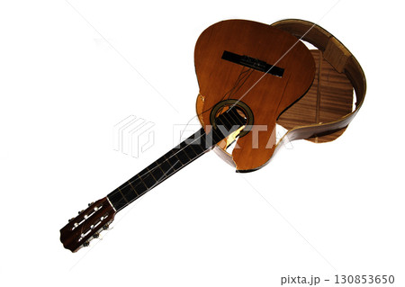 A broken smashed acousitic guitar music instrument on white background 130853650