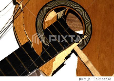 A broken smashed acousitic guitar music instrument on white background A broken smashed acousitic guitar music instrument on white background 130853658