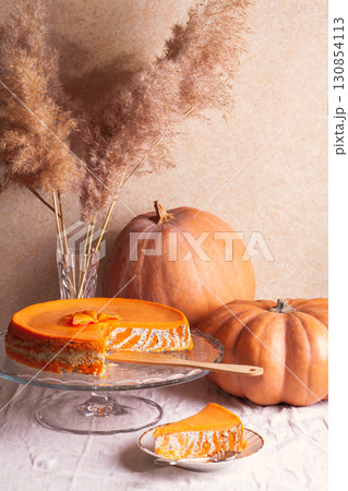 Homemade cottage cheese and pumpkin striped casserole with poppy seeds and orange on the table with pumpkins and reeds Homemade cottage cheese and pumpkin striped casserole with poppy seeds and orange on the table with pumpkins and reeds 130854113