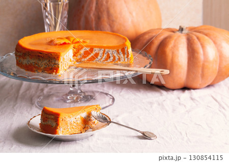 Homemade cottage cheese and pumpkin striped casserole with poppy seeds and orange and cut piece and pumpkins 130854115