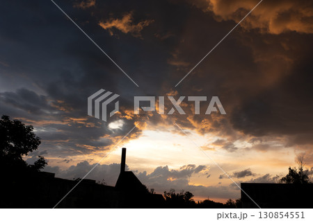 Beautiful evening sky with dark clouds over the city 130854551