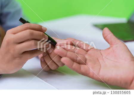 Closeup of hands engaging in a colorful, creative activity with a marker 130855605
