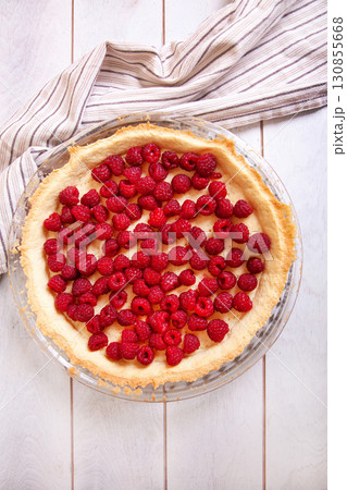 Preparation of shortbread pie with raspberries on white wooden background, top view Preparation of shortbread pie with raspberries on white wooden background, top view 130855668
