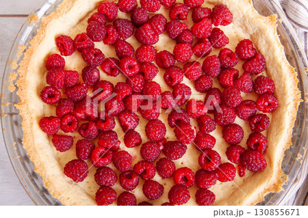 Preparation of shortbread pie with raspberries on a white wooden background, top view close up 130855671