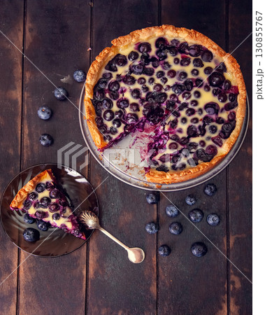 Rustic shortbread pie with blueberries in sour cream filling on a wooden background. Top view flat lay Rustic shortbread pie with blueberries in sour cream filling on a wooden background. Top view flat lay 130855767
