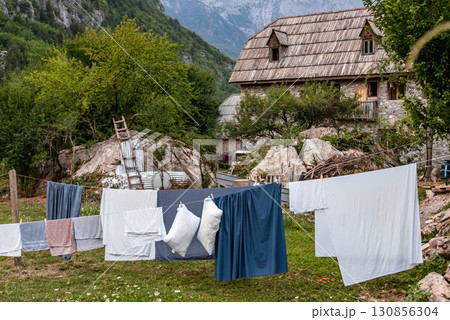 Rural Scene with Laundry Drying on Ropes near House Rural Scene with Laundry Drying on Ropes near House 130856304