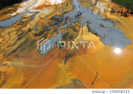 Patterns of acid mine drainage in decanting lake, nature pollution, aerial view 130856331