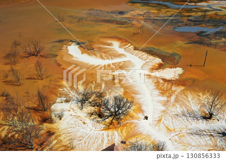 Patterns of acid mine drainage in decanting lake, nature pollution, aerial view Patterns of acid mine drainage in decanting lake, nature pollution, aerial view 130856333