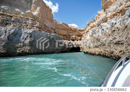 View of cliffs and caves turquoise water on Portugal Algarve coast from a boat View of cliffs and caves turquoise water on Portugal Algarve coast from a boat 130856662