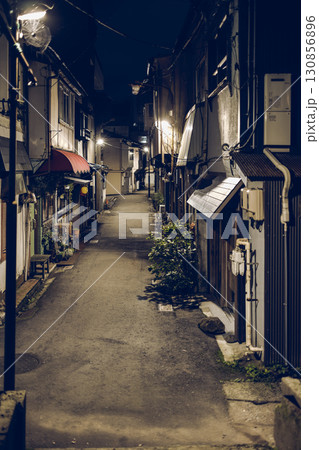 Quiet night alley in Kanazawa with dim light vintage film style traditional houses 130856896