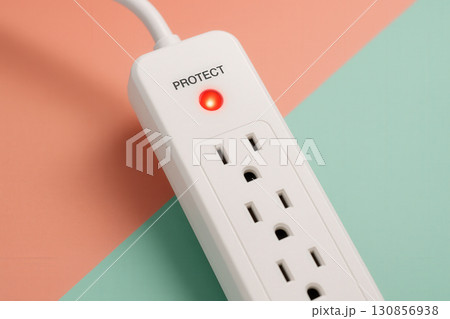 White Surge Protector with Active Indicator on Pastel Background 130856938