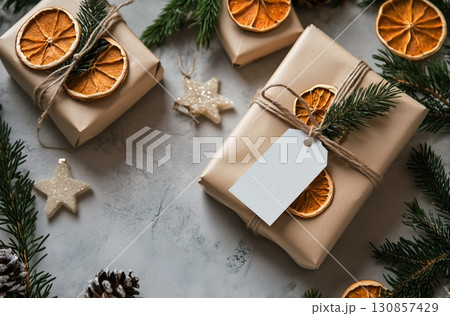 Festive Gift Wrapped With Natural Decorations on a Light Surface During the Holiday Season. 130857429