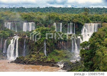 Powerful Iguazu Falls, one of the world's most impressive waterfalls. Brazil side. Brazilian wilderness landscape. 130857540